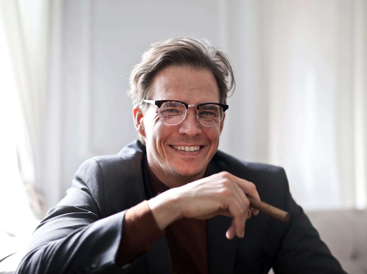 Adult man with cigar smiling at camera